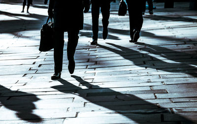 Low section of man walking on road