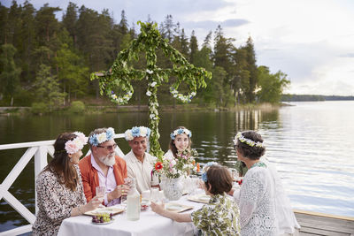 Family having midsummer dinner by lake