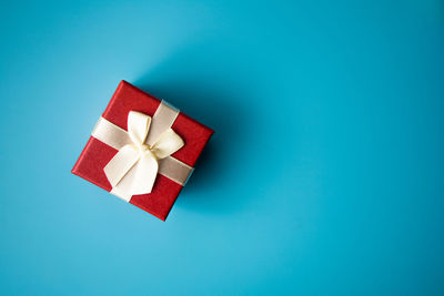 High angle view of red paper over blue background