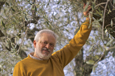 Portrait of man with arms raised