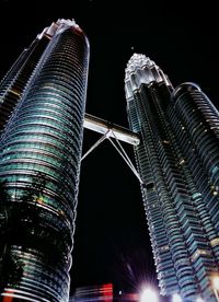 Low angle view of illuminated skyscraper against sky at night