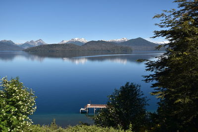 Scenic view of lake against clear blue sky