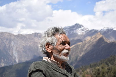 Portrait of man in mountains against sky