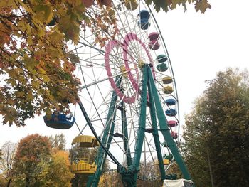 Low angle view of ferris wheel against sky