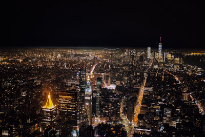 High angle view of city lit up at night