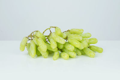 Close-up of green chili pepper against white background