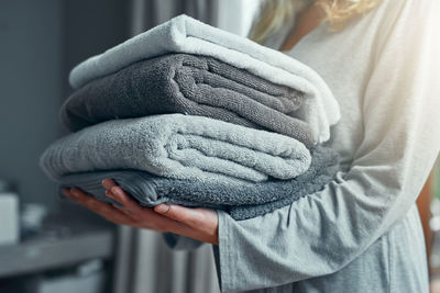 Rear view of woman with towels at home