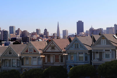 Modern buildings in city against clear sky