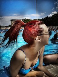 Portrait of woman sitting in swimming pool