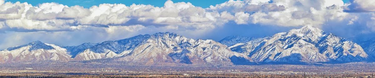 Panoramic view of snowcapped mountains against sky