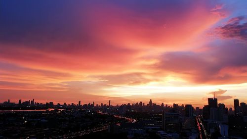 Aerial view of buildings against sky during sunset