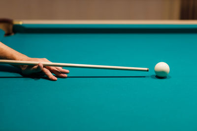 Cropped hand playing pool