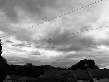 Low angle view of trees and buildings against sky