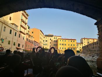 People in city against clear sky