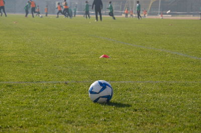 People playing soccer ball on field