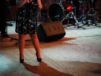 Low section of woman standing on stage