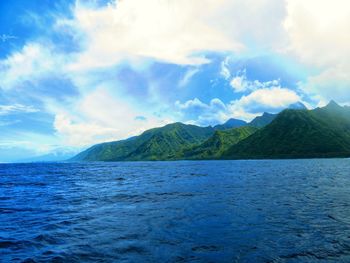 Scenic view of sea and mountains against sky