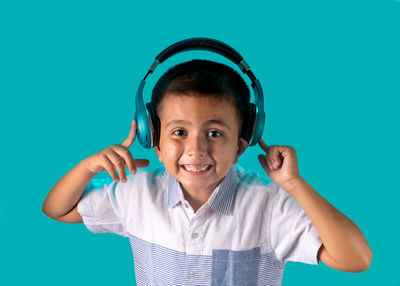 Portrait of smiling boy against blue background