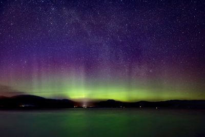 Scenic view of landscape against sky at night