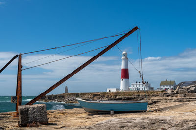 Ship moored on beach against clear blue sky