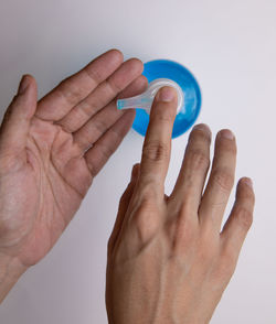 Close-up of human hand against white background