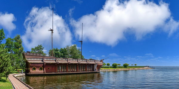 Panoramic view of boats in river against cloudy sky