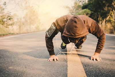 Man exercising on road