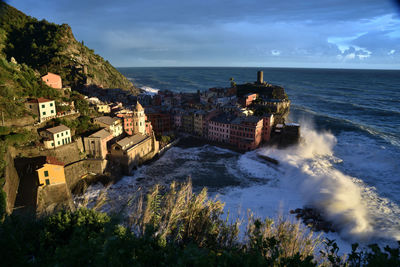 High angle view of buildings by sea against sky