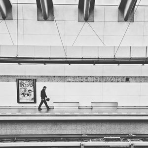 Full length of man walking at railroad station