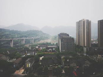 High angle view of buildings in city against sky