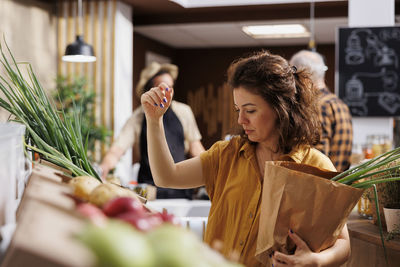 Portrait of young woman holding vegetables