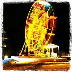 Illuminated ferris wheel at night