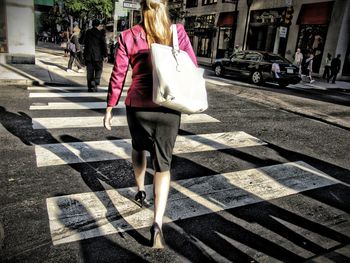 Woman standing on sidewalk