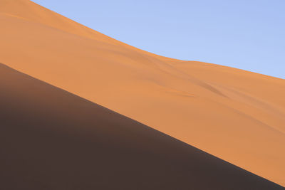 Low angle view of desert against clear sky