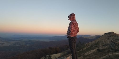 Man standing on mountain against sky