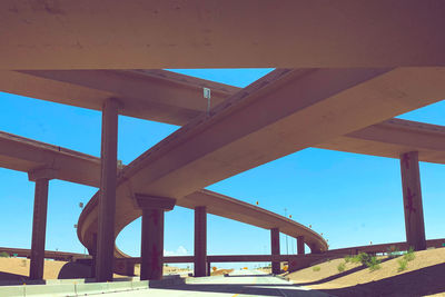 Low angle view of bridge against clear blue sky