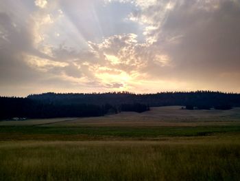 Scenic view of field against sky during sunset