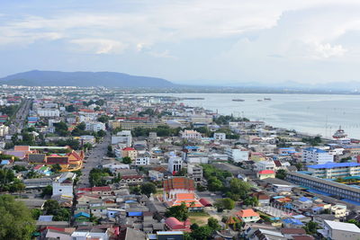 High angle view of townscape by sea against sky