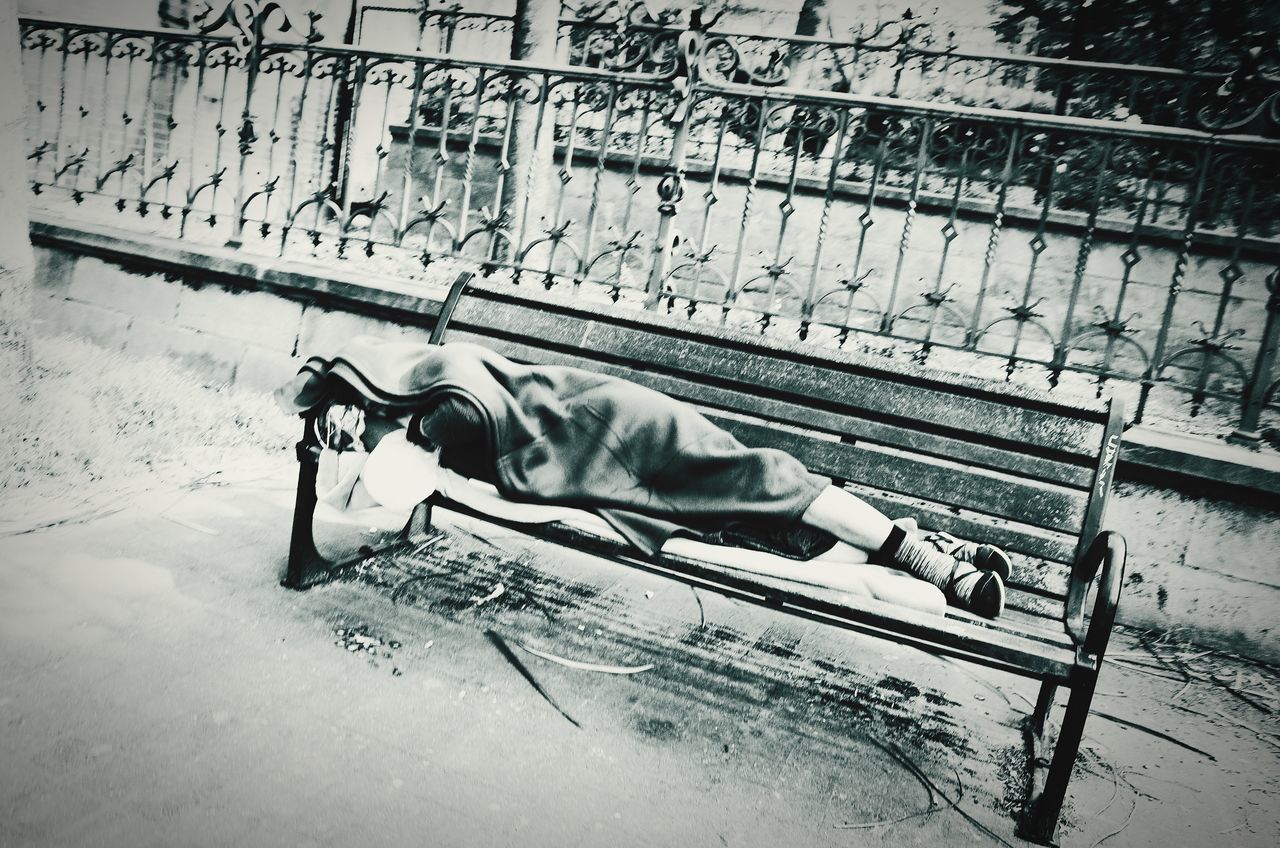 HIGH ANGLE VIEW OF MAN LYING DOWN IN STREET