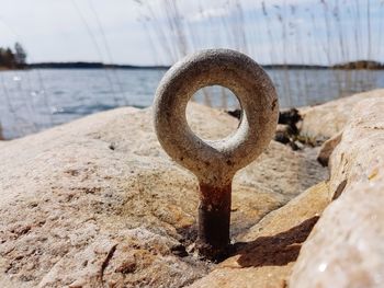 Close-up of rusty chain on beach