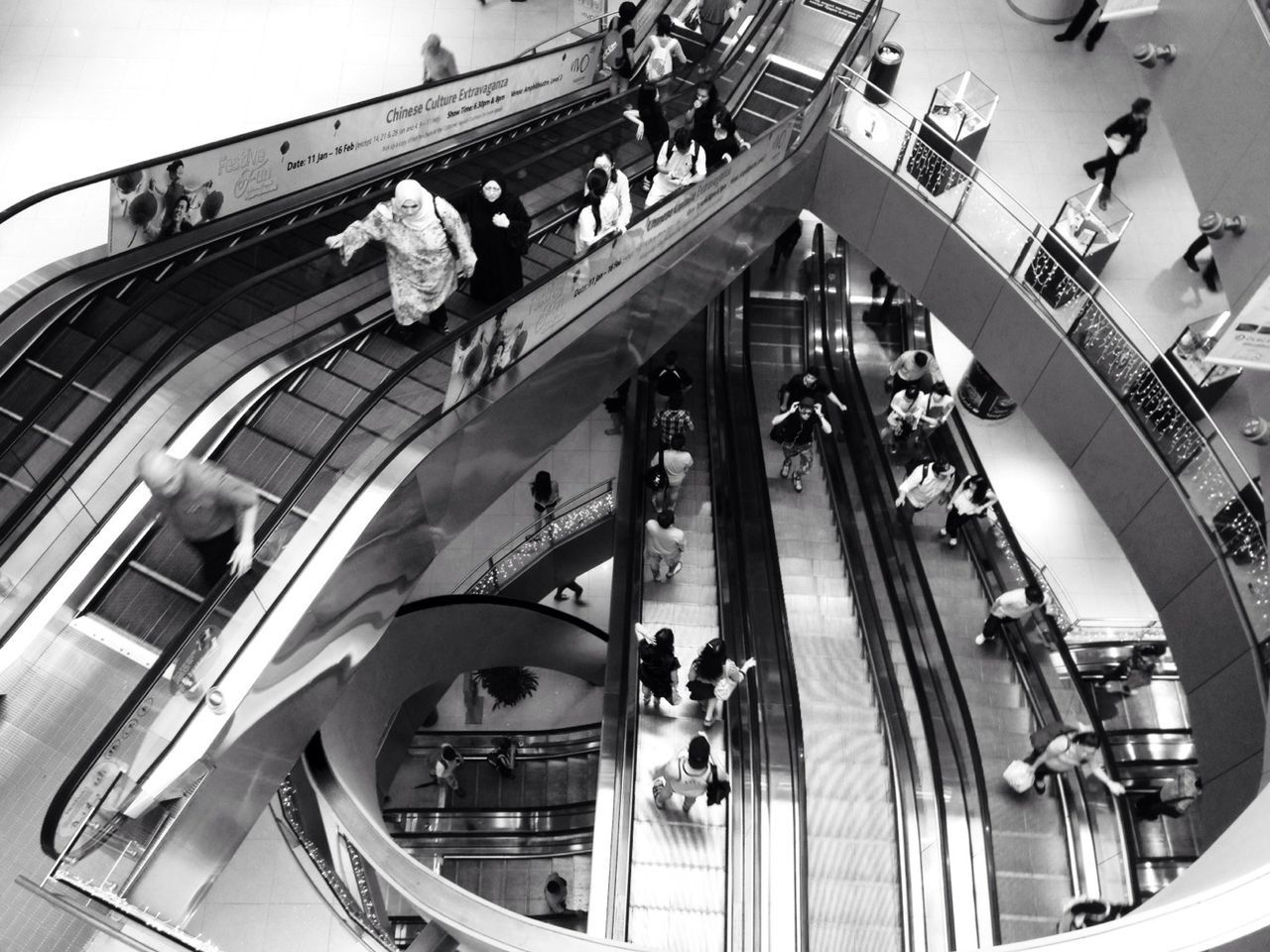 transportation, mode of transport, indoors, architecture, railing, built structure, high angle view, travel, incidental people, staircase, metal, steps, steps and staircases, land vehicle, men, railroad station, day, public transportation, bridge - man made structure, escalator