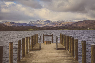 View of jetty leading to calm sea