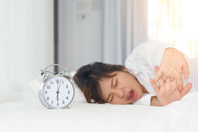 Cute boy sleeping on bed at home