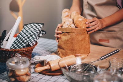 Midsection of woman holding food on table
