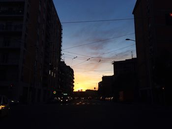 Buildings in city at sunset