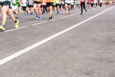 Group of people running on street