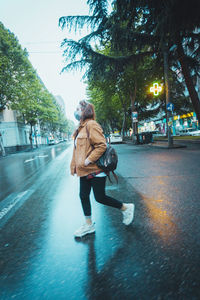 Woman walking on street in city