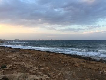 Scenic view of beach against sky during sunset