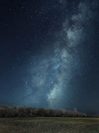 Scenic view of field against sky at night