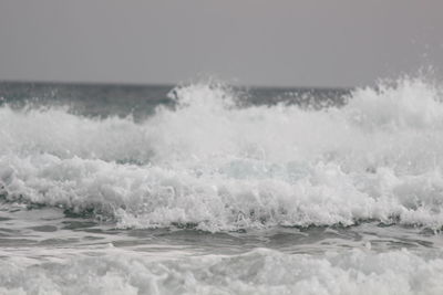 Close-up of waves in sea against sky